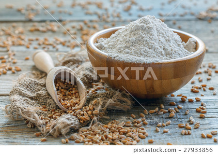 Wheat flour and scoop with the grain. 27933856