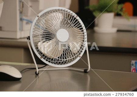 PC mouse and desk fan on the desk PC mouse and desk fan on the desk 27934760