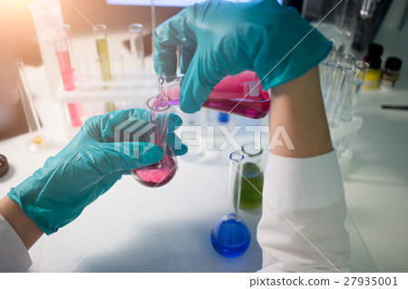 Lab assistant carries chemical testing Lab assistant carries chemical testing 27935001