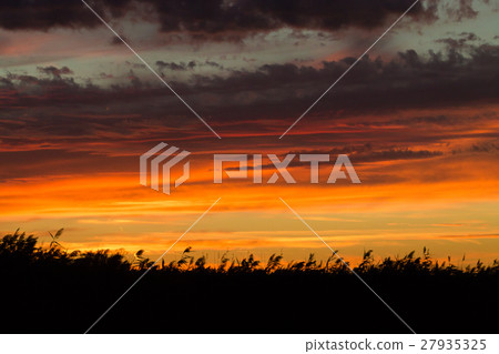 Sunset over water 27935325