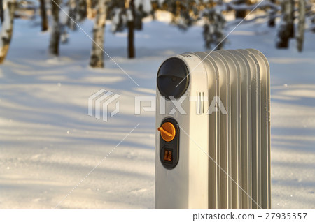 Heating radiator standing in snowy winter forest 27935357