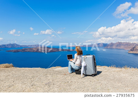 Young woman and laptop on the seafront 27935675