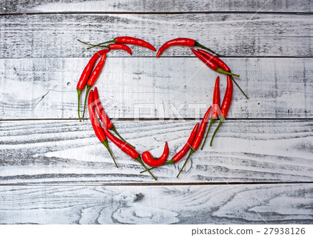 Hot and spicy red chilli on wood table background Hot and spicy red chilli on wood table background 27938126
