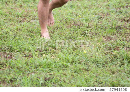 barefoot step on green grass field with copy space barefoot step on green grass field with copy space 27941308