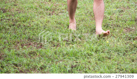 barefoot step on green grass field with copy space 27941309