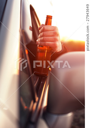 Drunk man drinking alcohol while driving a car Drunk man drinking alcohol while driving a car 27943649