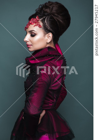 Beautiful girl in evening dress with avant-garde 27945217