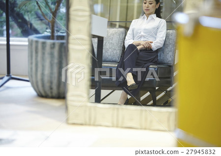Woman sitting on the couch 27945832