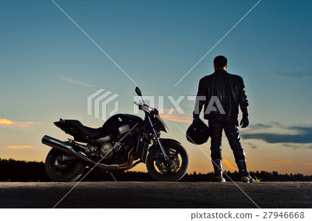 Male biker in leather outfit standing next to bike Male biker in leather outfit standing next to bike 27946668