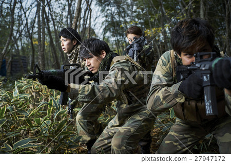 Men and women playing survival games 27947172