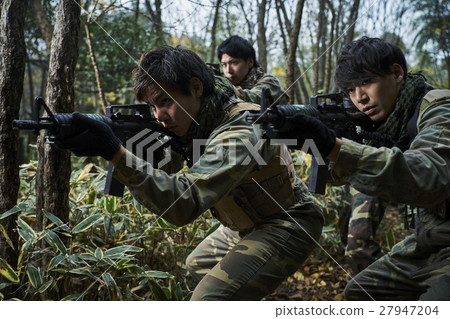 Men and women playing survival games Men and women playing survival games 27947204