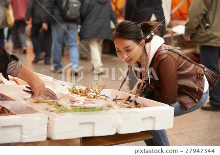 A woman sightseeing in morning market A woman sightseeing in morning market 27947344