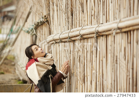 A woman observing a village in Makigaki 27947433