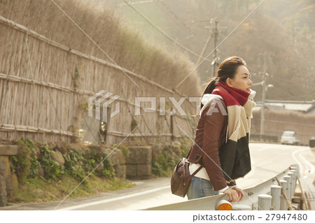 A woman observing a village in Makigaki 27947480