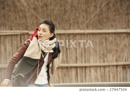 A woman observing a village in Makigaki 27947504