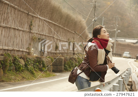 A woman observing a village in Makigaki 27947621