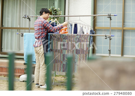 Male husband who hangs up the laundry 27948080
