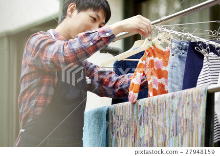 Male husband who hangs up the laundry 27948159