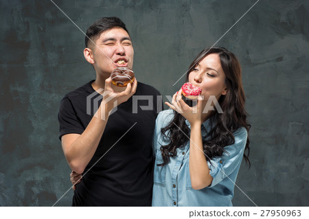 Young asian couple enjoy eating of sweet colorful 27950963