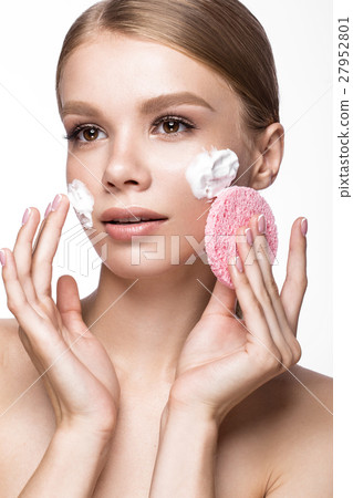 Beautiful young girl with sponge and foam cleanser 27952801