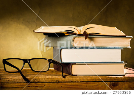 open book with reading glasses 27953596
