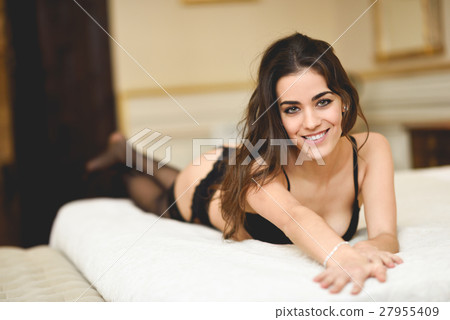 Sexy young woman in lingerie posing on the bed Sexy young woman in lingerie posing on the bed 27955409