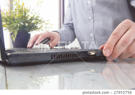 Man is connecting black hdmi cable into laptop Man is connecting black hdmi cable into laptop 27955756