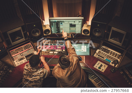 Sound engineer and musician recording song in 27957668