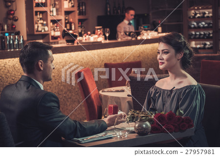 Handsome man holding box with ring making propose Handsome man holding box with ring making propose 27957981