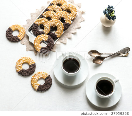 Chocolate cookies with two cups of coffee 27959268