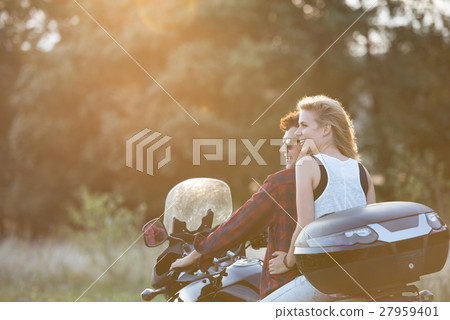 Couple in love enjoying a motorbike ride in 27959401