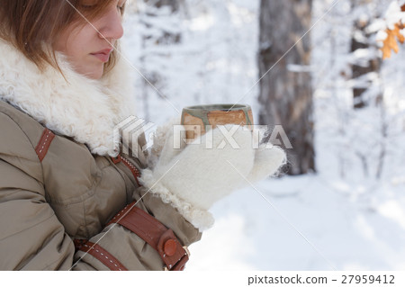 Young woman in winter coat and fluffy mittens Young woman in winter coat and fluffy mittens 27959412