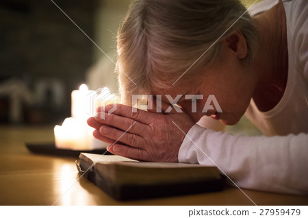 Senior woman praying, hands clasped together on 27959479