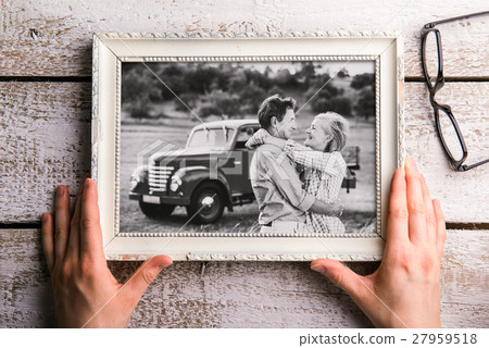 Hands holding black-and-white photo of seniors in Hands holding black-and-white photo of seniors in 27959518
