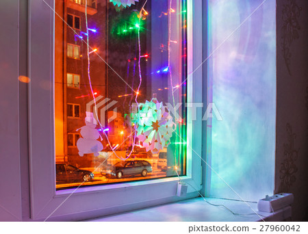 bright colored electric garland in the window 27960042