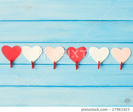 Hearts and red clothespins over turquoise wood Hearts and red clothespins over turquoise wood 27961925