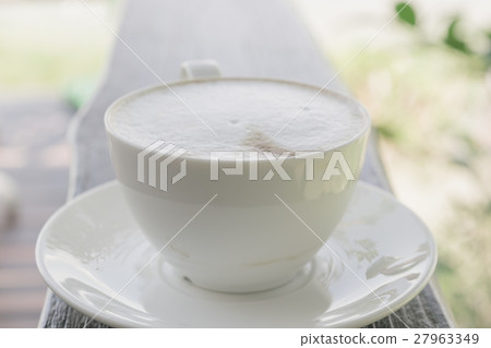 Cup of coffee on wooden table in cafe. Cup of coffee on wooden table in cafe. 27963349