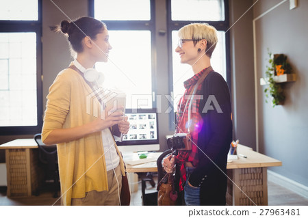 Graphic designers smiling while talking Graphic designers smiling while talking 27963481
