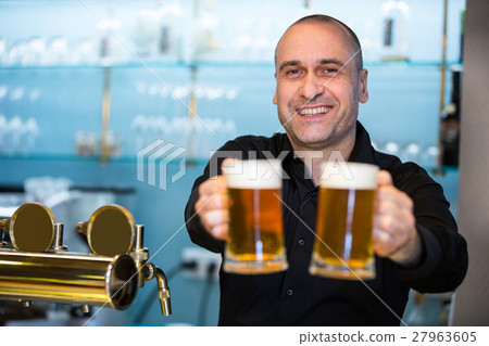 Portrait of bar tender offering beer 27963605