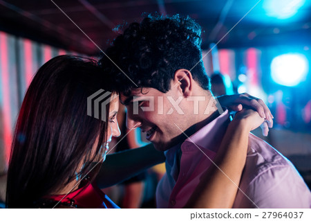 Cute couple dancing together on dance floor 27964037