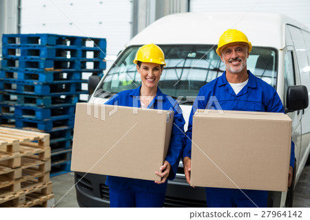 Smiling workers looking at camera Smiling workers looking at camera 27964142