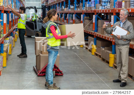 Manager looking a worker holding cardboard boxes with thumbs up Manager looking a worker holding cardboard boxes with thumbs up 27964257