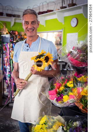 Male florist holding bunch of yellow sunflower Male florist holding bunch of yellow sunflower 27964364