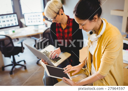 Two female graphic designer using digital tablet and laptop 27964597