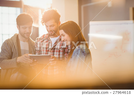 Graphic designer using digital tablet with his coworker 27964618