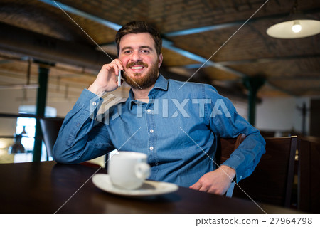 Man talking on mobile phone Man talking on mobile phone 27964798