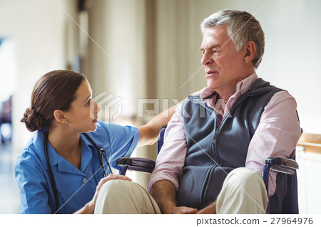 Nurse taking care of sad senior man 27964976