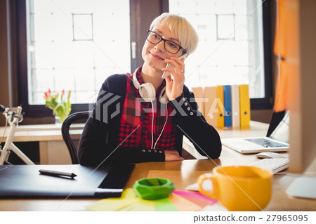 Graphic designer talking on mobile phone 27965095