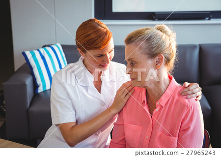 Nurse taking care of a sad senior woman Nurse taking care of a sad senior woman 27965243