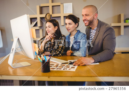 Team of graphic designer working on computer 27965356